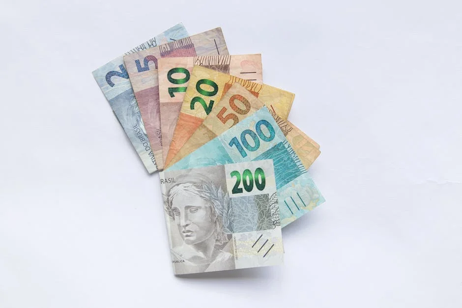 A fan arrangement of colorful Brazilian Real banknotes on a white background showcasing different values.